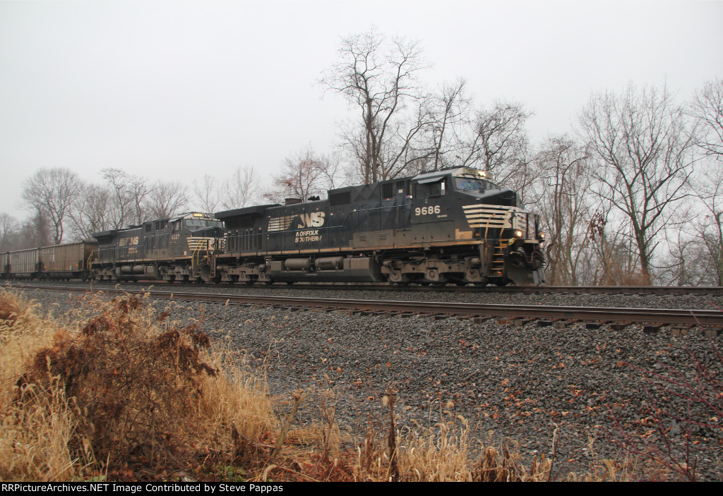 NS 9686 with aneastbound train of coal hoppers